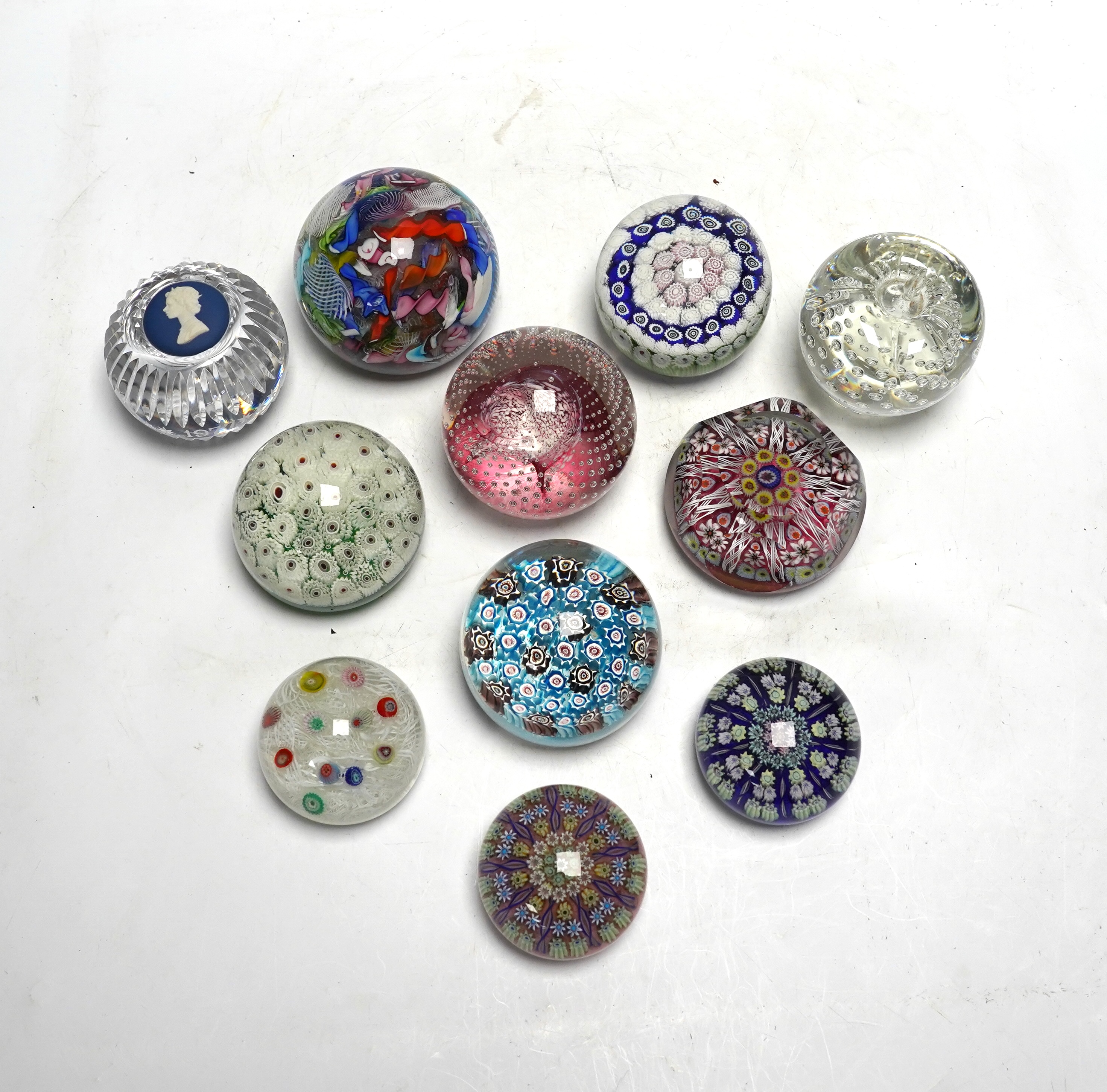 Eleven mixed Scottish and other glass paperweights including Caithness, largest 8.5cm in diameter